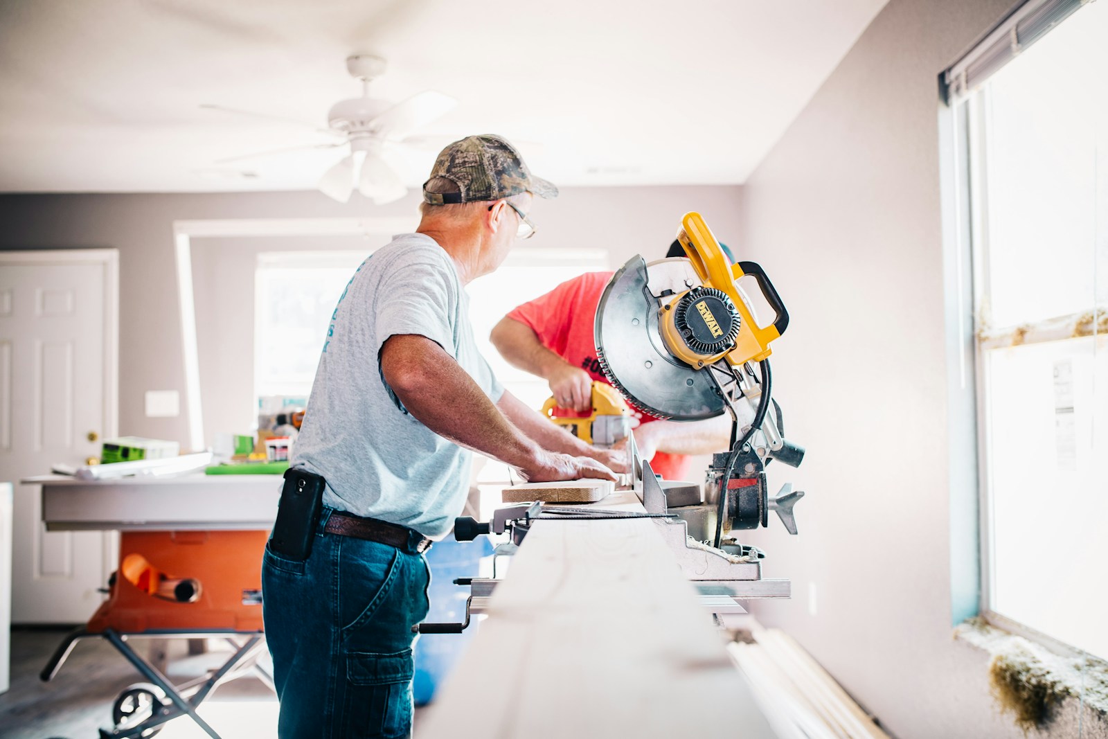 man standing infront of miter saw, home